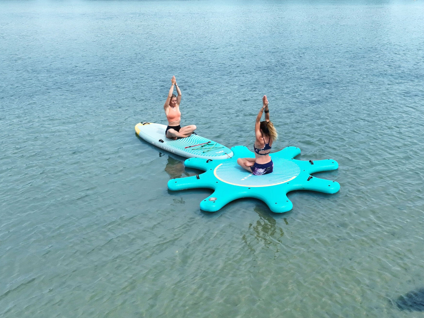 Instructor leading floating yoga class on paddleboards in Montana – Book at MontanaBoardingSchool.com.