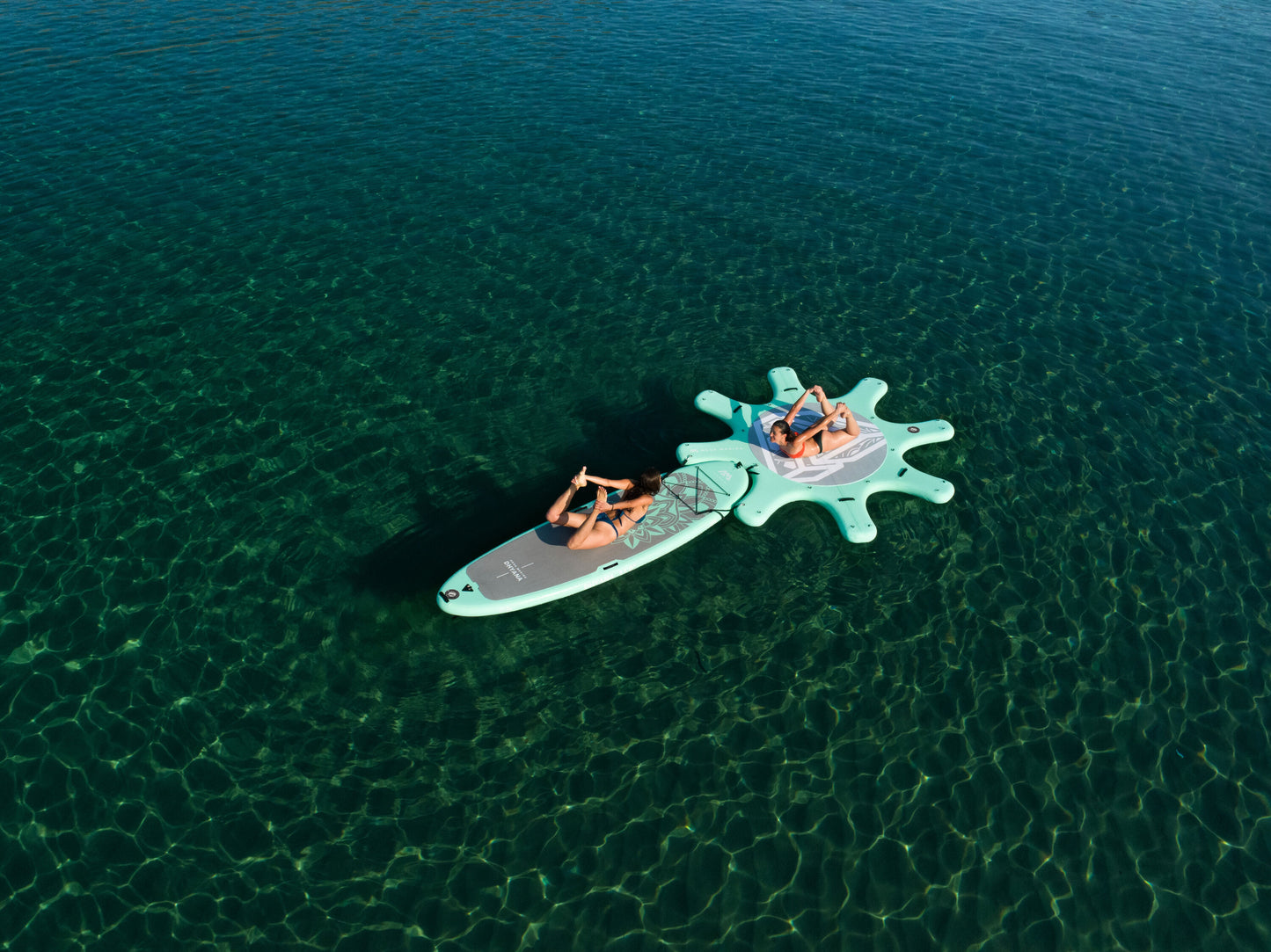 Instructor leading floating yoga class on paddleboards in Montana – Book at MontanaBoardingSchool.com.