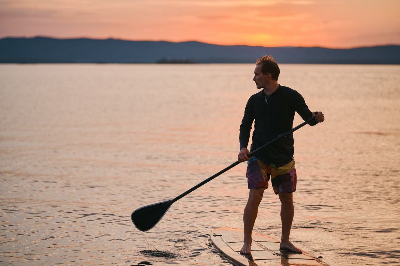 Rider on electric paddleboard on Montana lake – eSUP session booking at MontanaBoardingSchool.com. Rent from MTBoarders.com or buy from E-Boarders.com