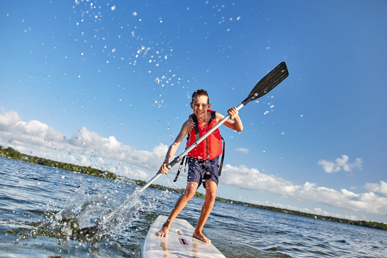 Rider on electric paddleboard on Montana lake – eSUP session booking at MontanaBoardingSchool.com. Rent from MTBoarders.com or buy from E-Boarders.com