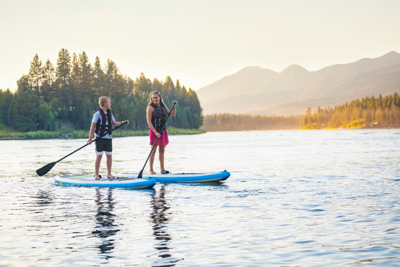 Beginner paddleboarding session with instructor on Montana lake – Private SUP lessons from MontanaBoardingSchool.com. Rent paddles from montanaboarders.com delivered to your lakefront vacation home in the Flathead Valley.