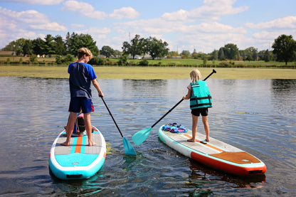 Beginner paddleboarding session with instructor on Montana lake – Private SUP lessons from MontanaBoardingSchool.com. Rent paddles from montanaboarders.com delivered to your lakefront vacation home in the Flathead Valley.